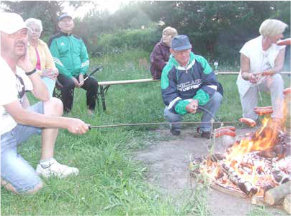 Osoby siedzące przy ognisku