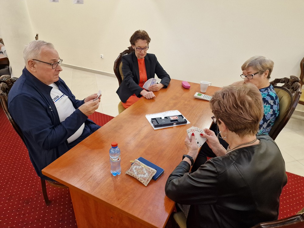 grupa osób grająca w brydza